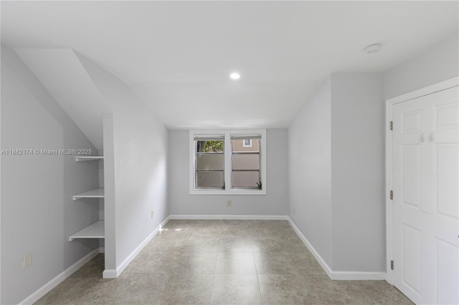 1408 Southwest 19th Terrace, Unit 1410 Miami, FL 33145 - Photo 8 of 12 an empty room with a empty space and window