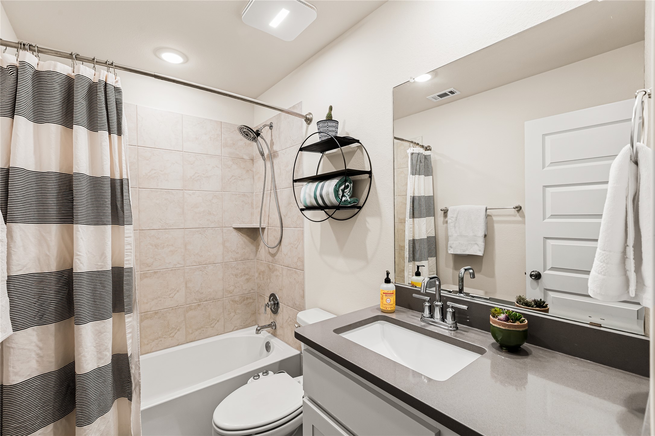862 Pepperbark Loop Buda, TX 78610 - Photo 26 of 40 a bathroom with a granite countertop tub sink toilet and shower