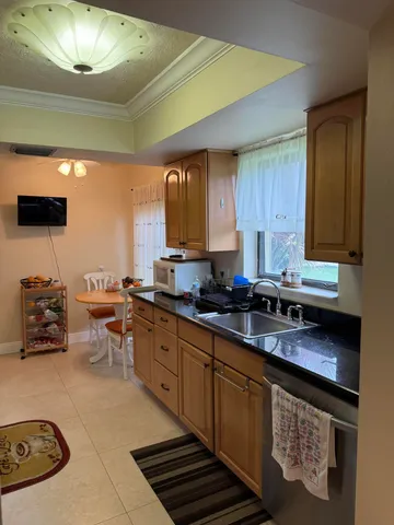 a kitchen with stainless steel appliances a stove a sink and a refrigerator