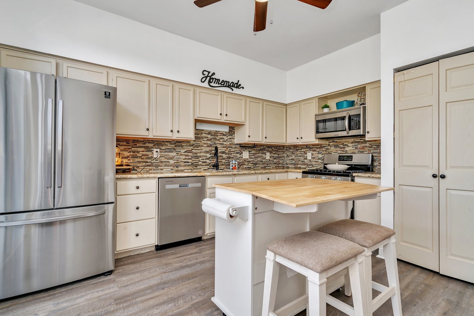 1750 Raleigh Trail Romeoville, IL 60446 - Photo 6 of 39 a kitchen with white cabinets and stainless steel appliances