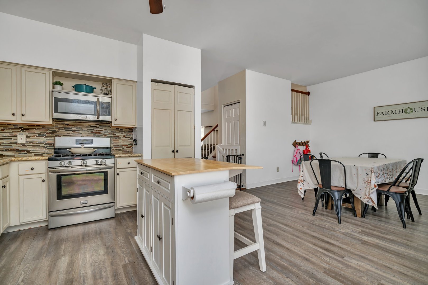 1750 Raleigh Trail Romeoville, IL 60446 - Photo 7 of 39 a kitchen with stainless steel appliances a stove a sink white cabinets and wooden floor