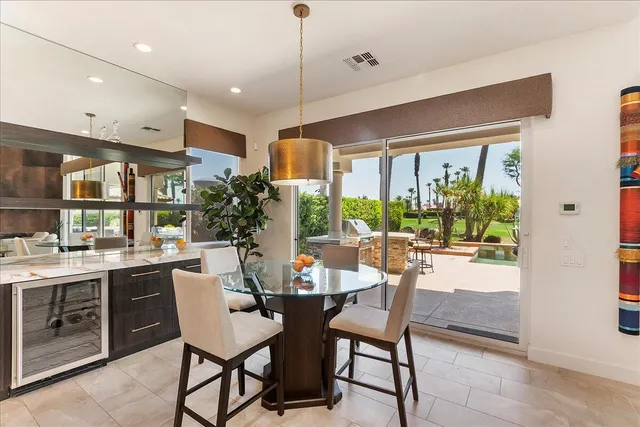 a large kitchen with a table and chairs