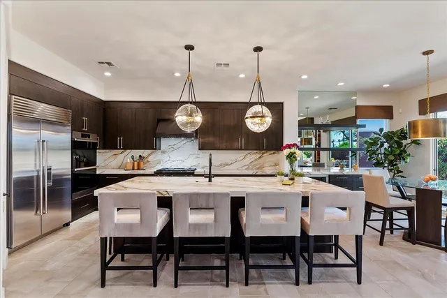 a large kitchen with a table and chairs