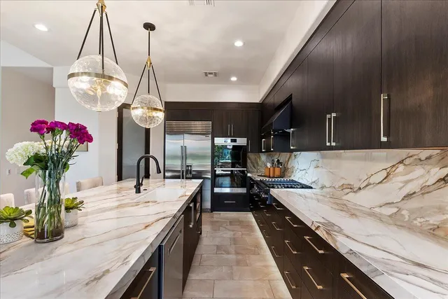 a kitchen with stainless steel appliances granite countertop a sink and cabinets