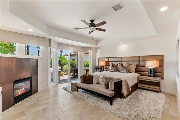 a bedroom with a large bed and a fireplace