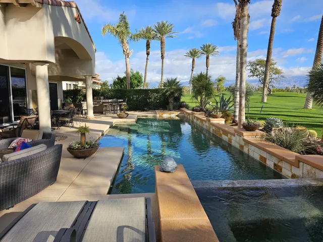 a front view of a house with a garden and yard