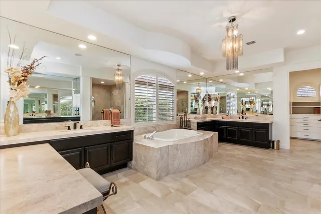 a large spacious bathroom with a large tub and sink