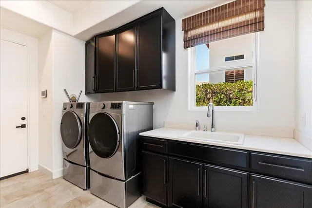 a view of a patio with table and chairs potted plants and palm tree