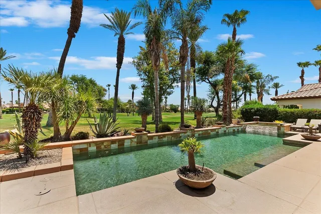 a view of a house with backyard porch and sitting area