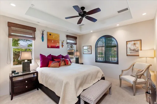 a bedroom with a bed a desk and chair