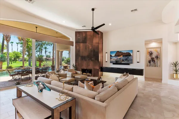 a living room with furniture and a chandelier