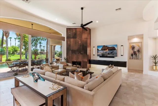 a living room with furniture and a chandelier