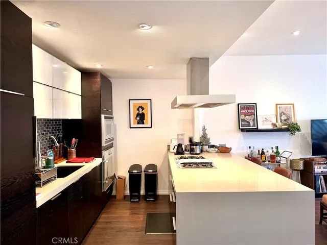 a kitchen with stainless steel appliances a sink stove and cabinets