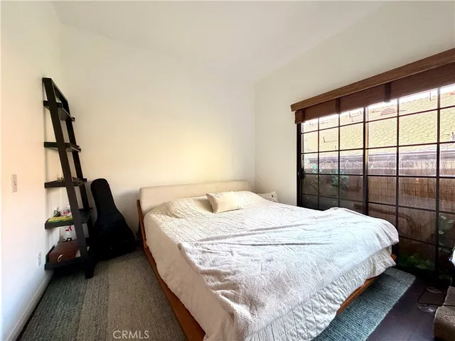 a bedroom with a bed and a window