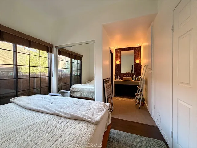 a bedroom with a bed and a large window