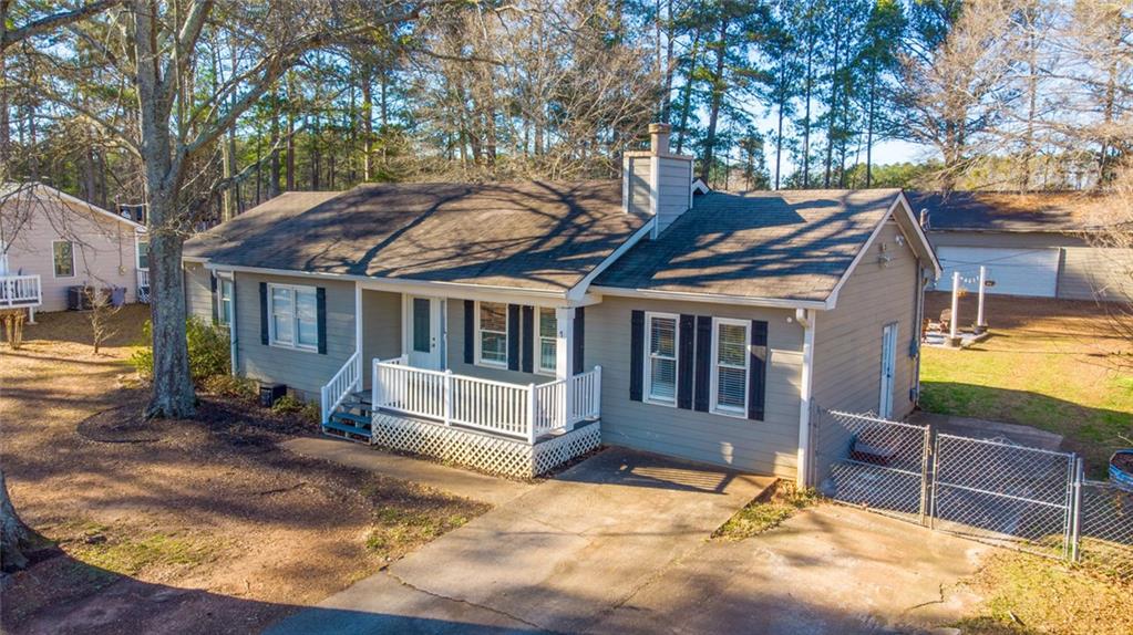 707 Reese Street Monroe, GA 30655 - Photo 11 of 61 a view of a house with a wooden fence and a large tree