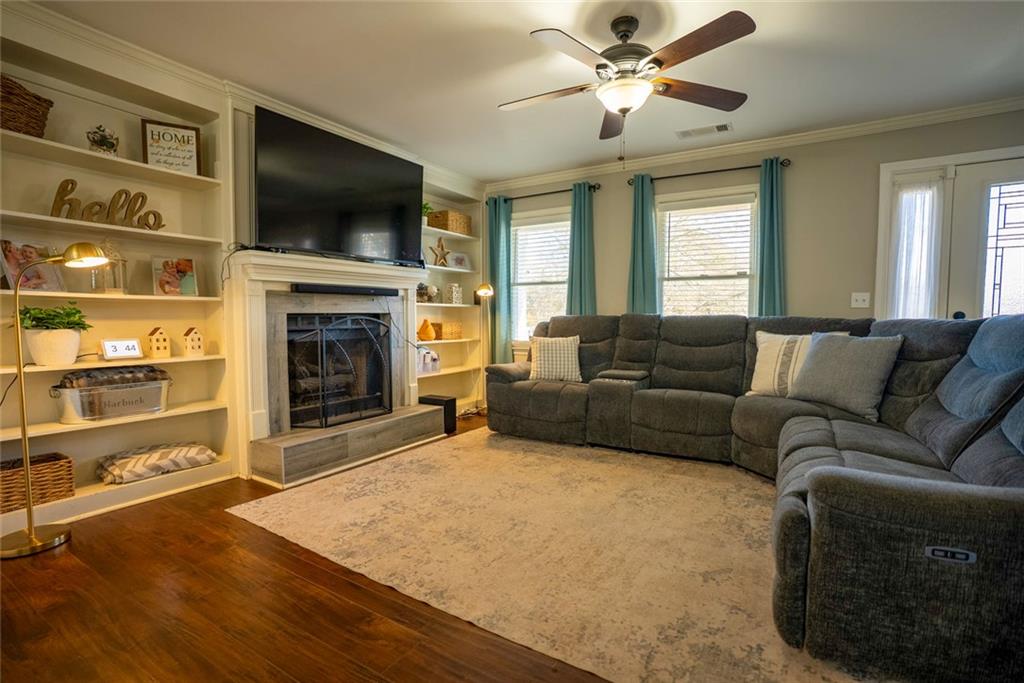 707 Reese Street Monroe, GA 30655 - Photo 13 of 61 a living room with furniture a flat screen tv and a fireplace