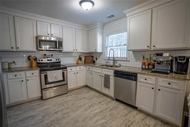 a kitchen with lots of counter top space and dining table