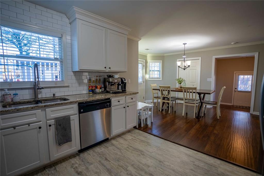 707 Reese Street Monroe, GA 30655 - Photo 20 of 61 a kitchen with lots of counter top space and dining table