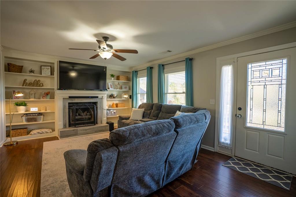 707 Reese Street Monroe, GA 30655 - Photo 2 of 61 a living room with furniture a flat screen tv and fireplace