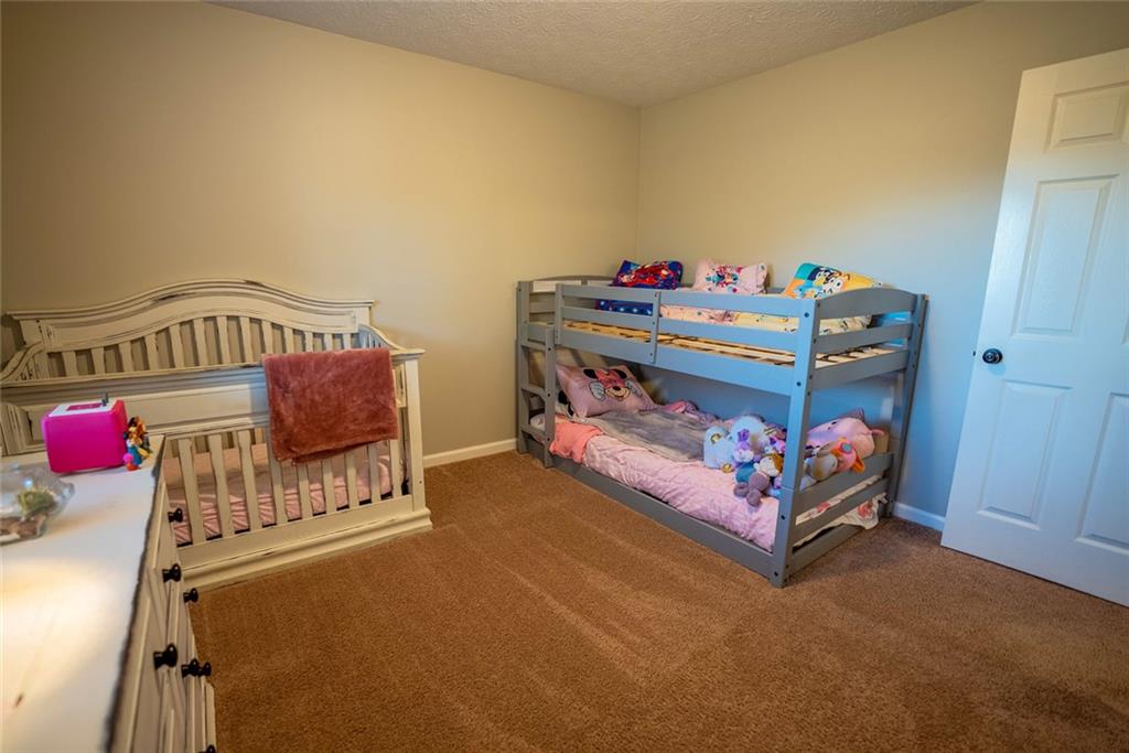 707 Reese Street Monroe, GA 30655 - Photo 23 of 61 a bedroom with a bed and wooden floor