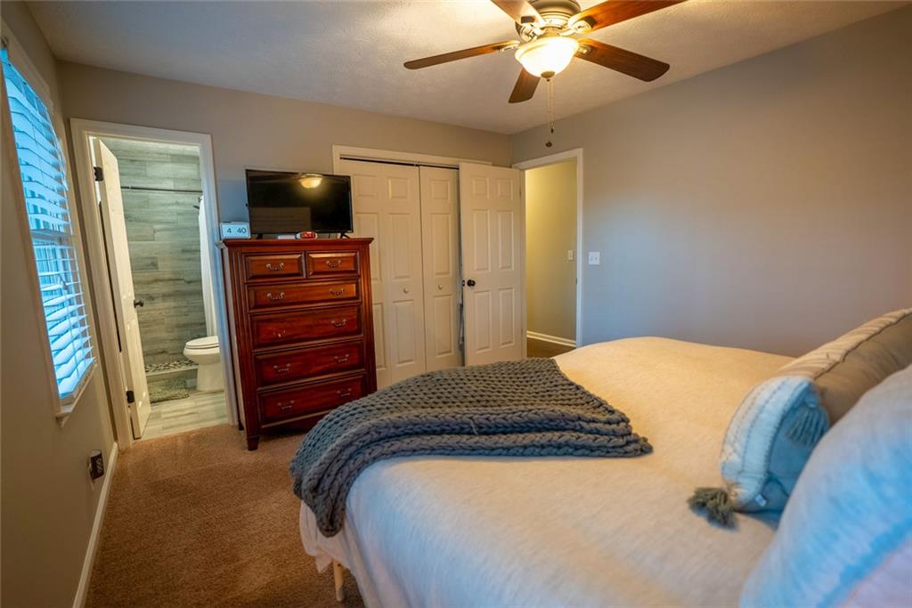 707 Reese Street Monroe, GA 30655 - Photo 28 of 61 a bedroom with a bed and a flat screen tv