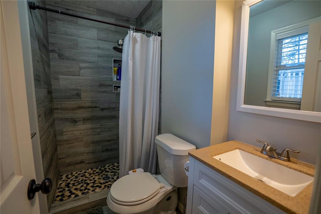 707 Reese Street Monroe, GA 30655 - Photo 29 of 61 a bathroom with a sink a toilet and shower