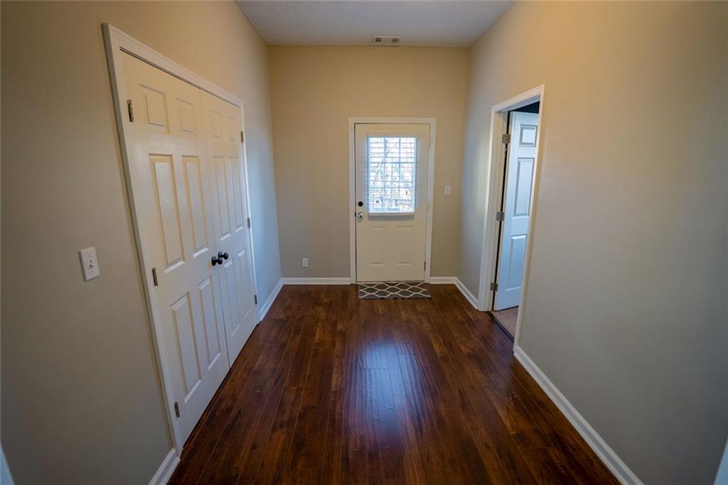 707 Reese Street Monroe, GA 30655 - Photo 30 of 61 a view of a hallway with wooden floor and stairs