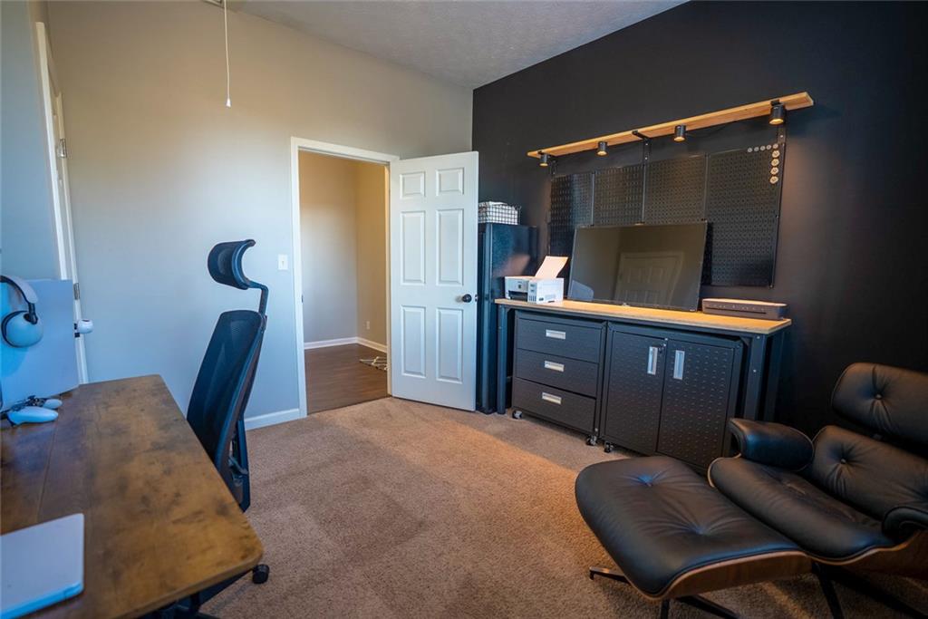 707 Reese Street Monroe, GA 30655 - Photo 33 of 61 a bed room with furniture and a chair