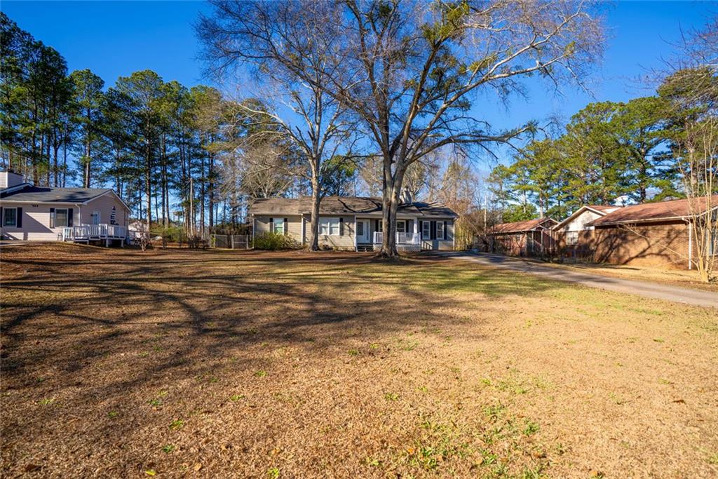 707 Reese Street Monroe, GA 30655 - Photo 34 of 61 a swimming pool with outdoor seating and trees