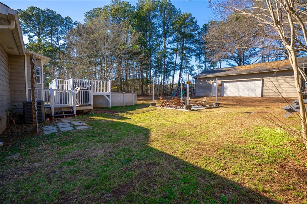 707 Reese Street Monroe, GA 30655 - Photo 40 of 61 a view of a yard with table and chairs and wooden fence