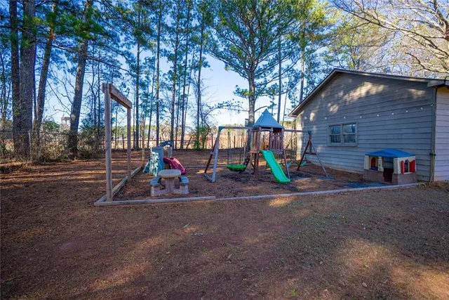 a view of a patio with chairs next to a yard