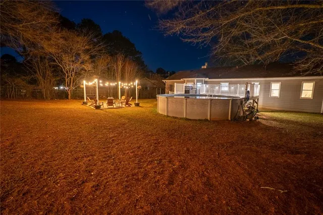 a view of a yard with plants and trees