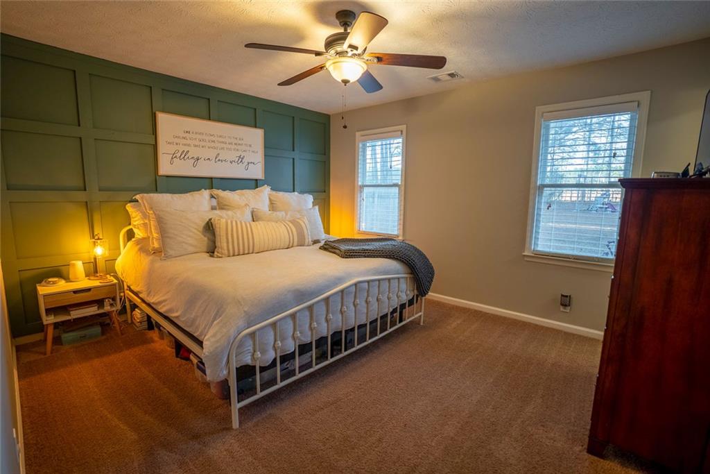 707 Reese Street Monroe, GA 30655 - Photo 5 of 61 a bed sitting in a bedroom next to a window