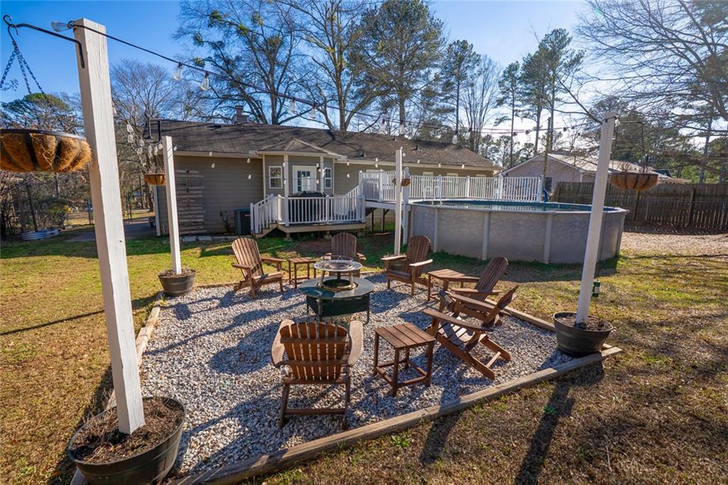 707 Reese Street Monroe, GA 30655 - Photo 51 of 61 a view of a patio with chairs next to a yard