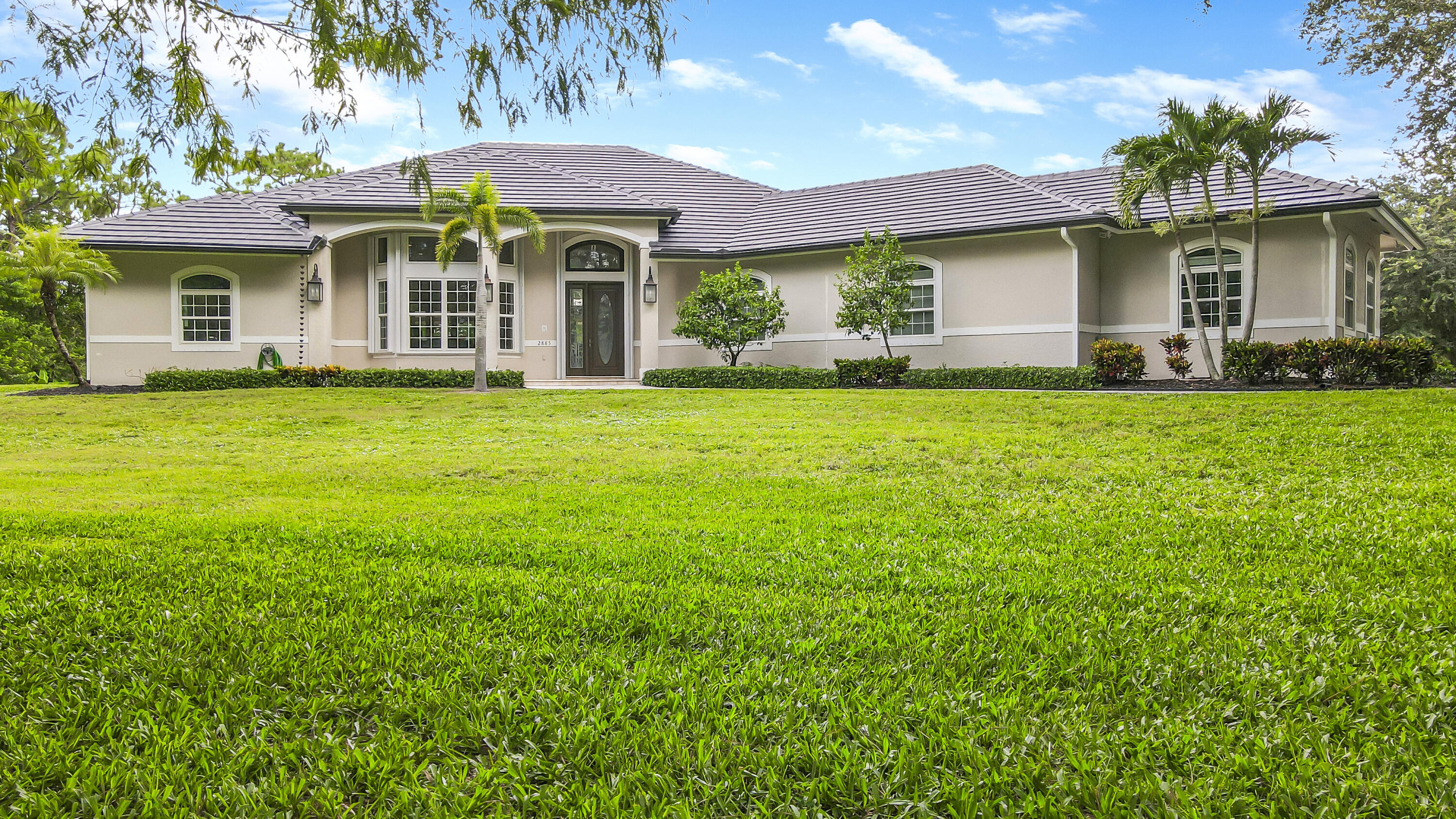 2885 Southeast Ranch Acres Circle Jupiter, FL 33478 - Photo 1 of 44 Front elevation