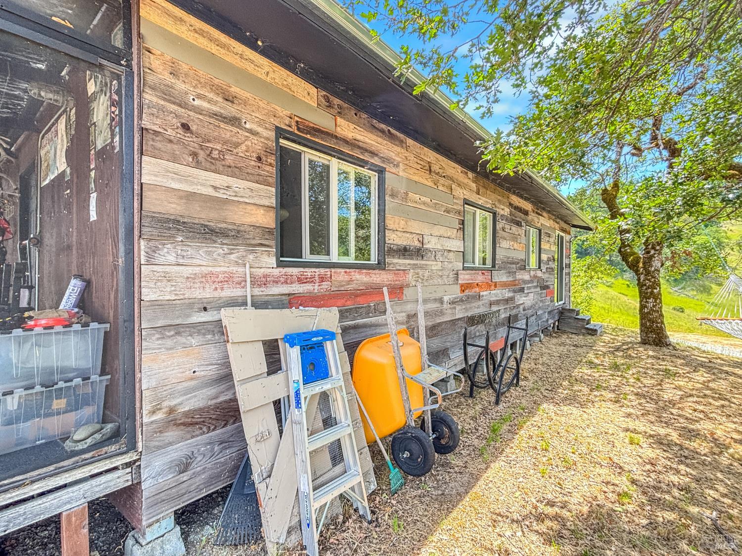 56801 Registered Guest Road Laytonville, CA 95454 - Photo 5 of 22 a view of a patio with table and chairs potted plants and large tree