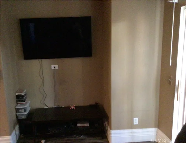 a living room with a flat screen tv and a window