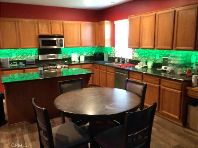 a kitchen with a table chairs sink and cabinets