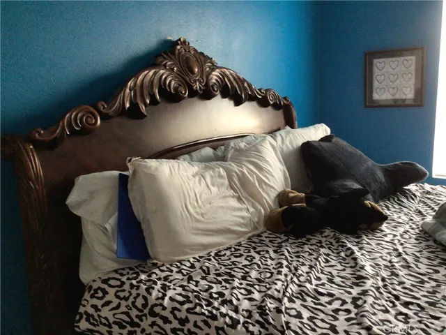 a bed sitting in a bedroom next to a window