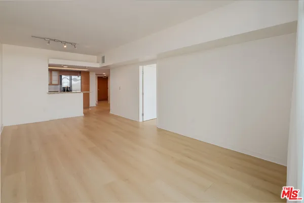 a kitchen with stainless steel appliances granite countertop a refrigerator and a stove