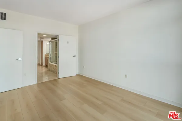 a bathroom with a granite countertop sink a mirror and a shower
