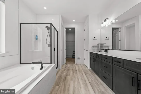a spacious bathroom with a tub shower and sink