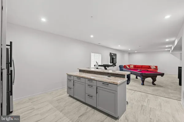 a kitchen with a sink cabinets and wooden floor