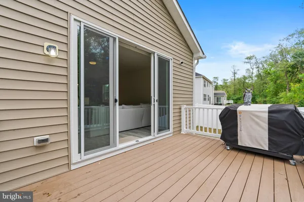 a view of a balcony with two chairs and wooden floor