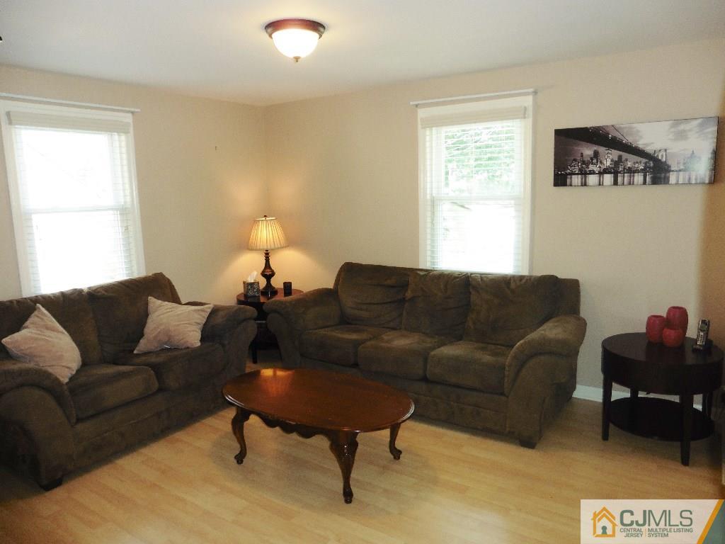 113 Highfield Road Colonia, NJ 07067 - Photo 2 of 25 a living room with furniture a couch and a window