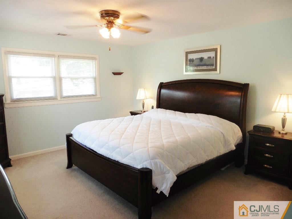113 Highfield Road Colonia, NJ 07067 - Photo 17 of 25 a large bed sitting in a bedroom next to a window