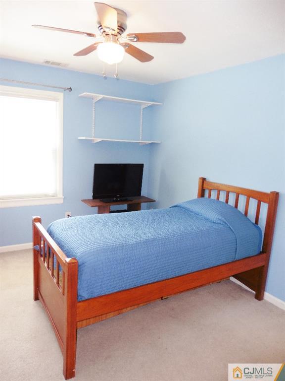 113 Highfield Road Colonia, NJ 07067 - Photo 20 of 25 a bed sitting in a bedroom next to a window