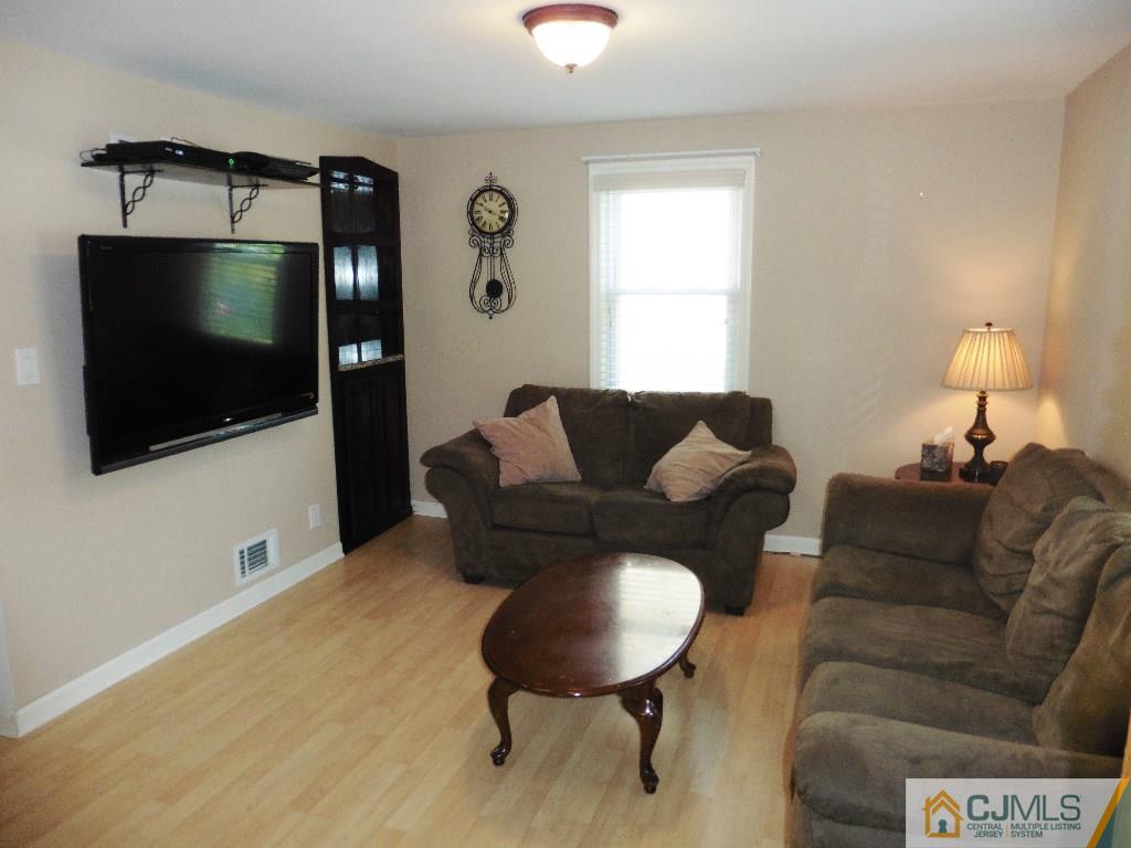 113 Highfield Road Colonia, NJ 07067 - Photo 3 of 25 a living room with furniture and a flat screen tv
