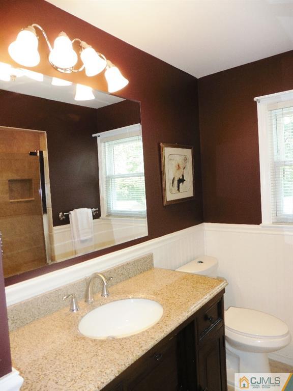 113 Highfield Road Colonia, NJ 07067 - Photo 22 of 25 a bathroom with a granite countertop sink and a mirror